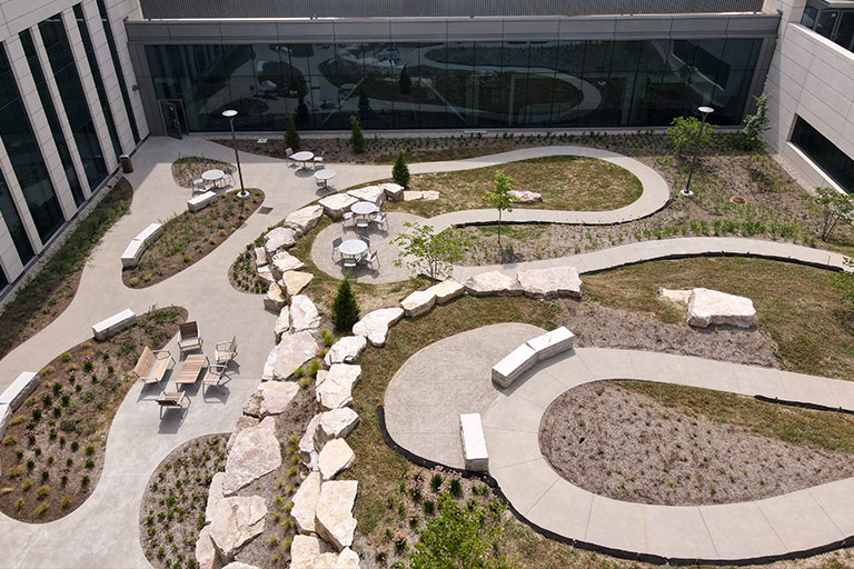 Aerial view of building courtyard with landscaping and winding paths